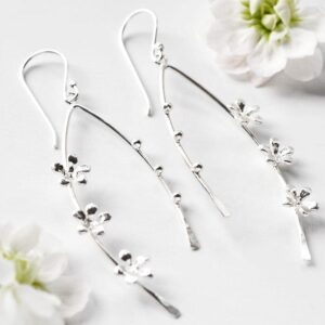 Silver arched bow earrings adorned with forget me nots