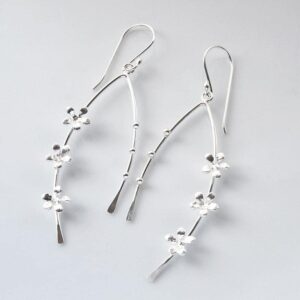 Silver arched bow earrings adorned with forget me nots