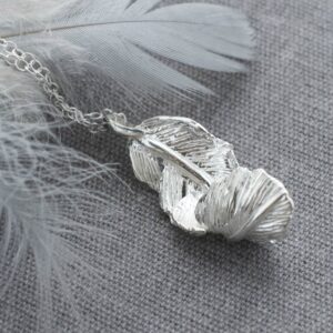 Silver furling feather pendant necklace