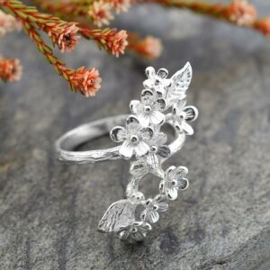 Silver cluster of forget me nots adorned on ring