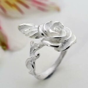 Silver blooming rose adorned on ring