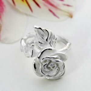 Silver blooming rose adorned on ring