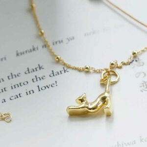 Gold Cat Necklace on a book background