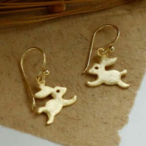 Gold Rabbit Earrings on brown background