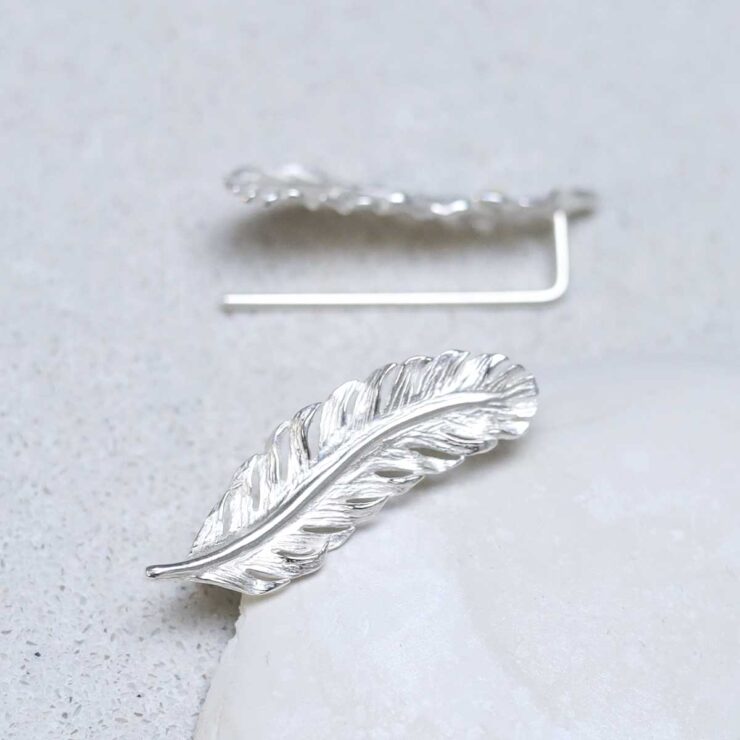Sterling Silver Feather Ear Climbers on stone