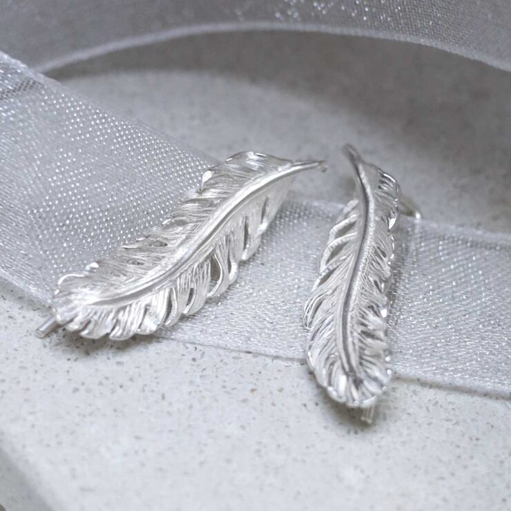 MB196_Sterling Silver Feather Ear Climbers_6 Sterling Silver Feather Ear Climbers on ribbon