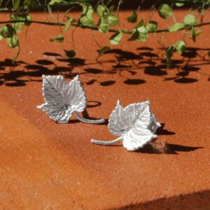 Silver Ivy Leaf Earrings with Terracotta background and little Green Leaves in background