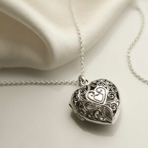 Sterling Silver Vintage Heart Locket on cream background with silk detail