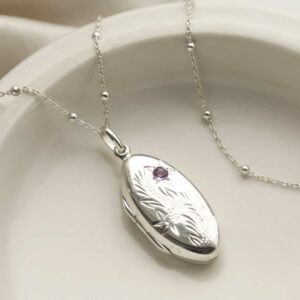 Sterling Silver Oval Locket with Amethyst on a satellite chain on white background