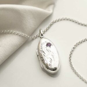 Sterling Silver Oval Locket with Amethyst on a white background with silk detail