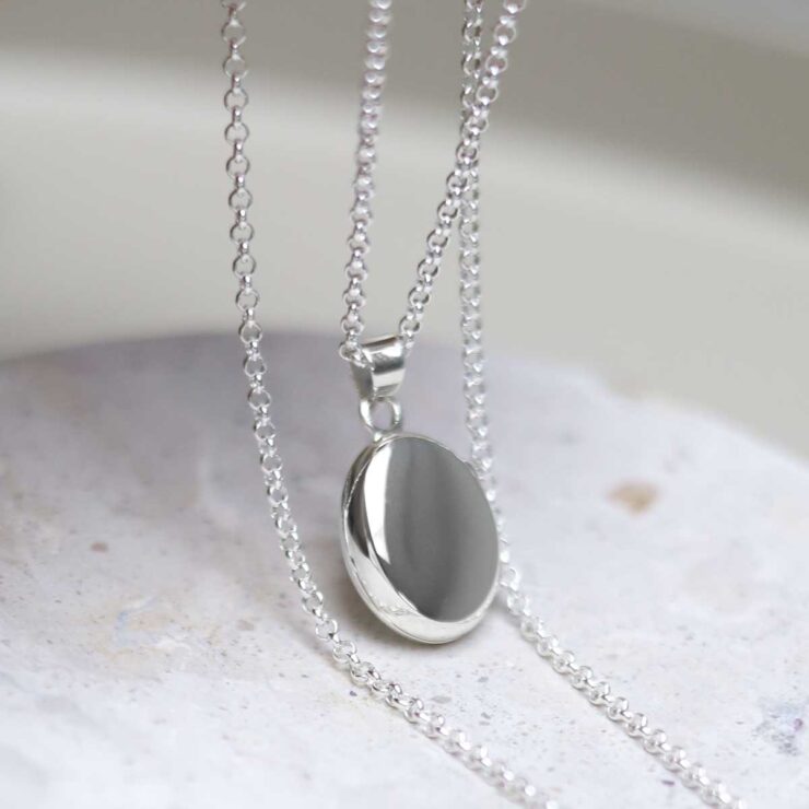 Sterling Silver Oval Locket Necklace on table