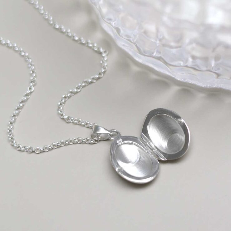 Sterling Silver Oval Locket Necklace on table