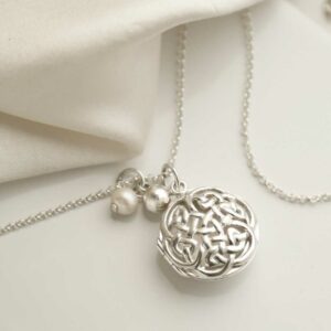 Sterling Silver Round Celtic Locket on silk background with add on charm