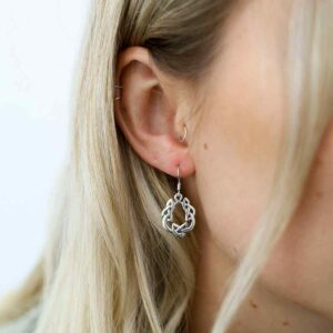 silver celtic round knot earrings polished on model