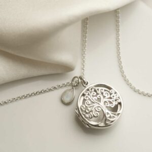 Sterling Silver Filigree Tree Locket with add on charm on silk background