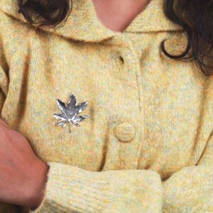 Moden In Green Jacket Wearing Sterling Silver Maple Brooch