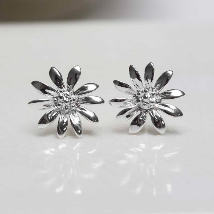 Sterling Silver Polished Daisy Stud Earrings on jewellery dish