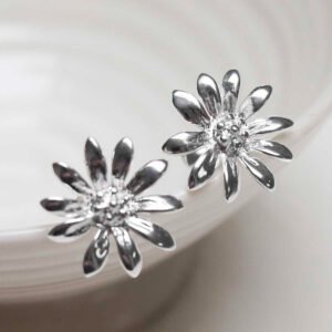 Sterling Silver Polished Daisy Stud Earrings on jewellery dish