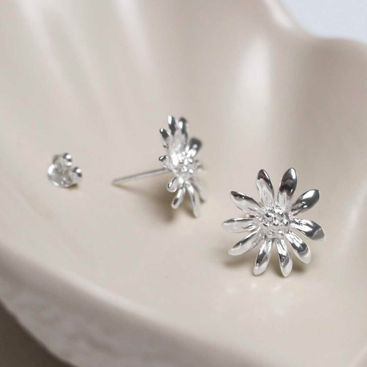 Sterling Silver Polished Daisy Stud Earrings on jewellery dish