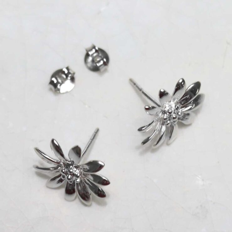 Sterling Silver Polished Daisy Stud Earrings on jewellery dish