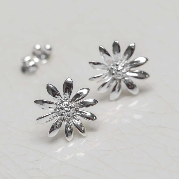 Sterling Silver Polished Daisy Stud Earrings on jewellery dish