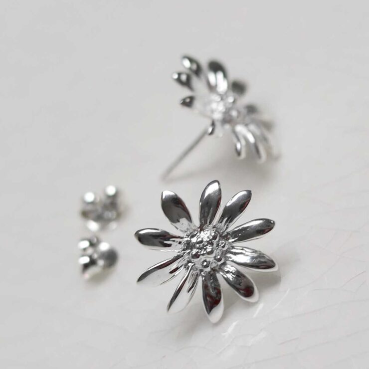 Sterling Silver Polished Daisy Stud Earrings on jewellery dish