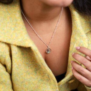 Model in green jacket wearing Sterling Silver Cat Necklace