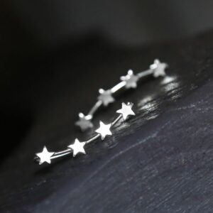 Silver 4 star ear climbers on grey slate back ground