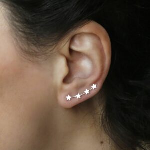 Silver 4 star ear climbers on models ear with black flowing hair