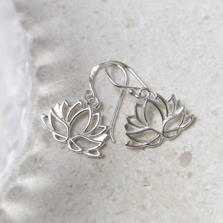 Sterling Silver Dangly Lotus Flower Earrings on table