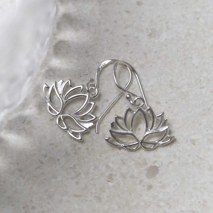 Sterling Silver Dangly Lotus Flower Earrings on table