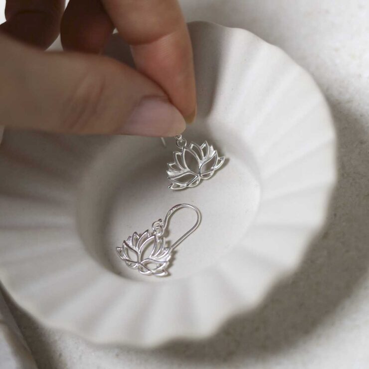 Sterling Silver Dangly Lotus Flower Earrings on jewellery tray