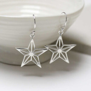 Sterling Silver Dangly Geometric Star Earrings on jewellery dish