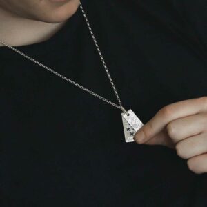 man wearing double tag cut out stars and meteorite slice necklace