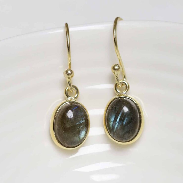 MJ751DG_1Sterling Silver Gold Plated Dangly Labradorite Oval Earrings_3 Sterling Silver Gold Plated Dangly Labradorite Oval Earrings on white dish