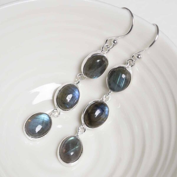 Sterling Silver Triple Labradorite Dangly Oval Earrings on white dish
