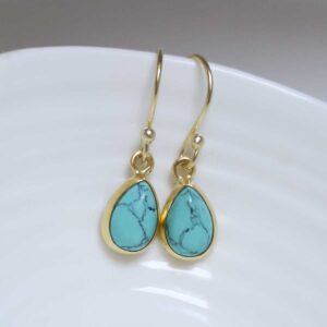 Sterling Silver Gold Plated Turquoise teardrop earrings on white dish