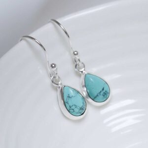 Sterling Silver Dangly Turquoise Teardrop Earring on white dish