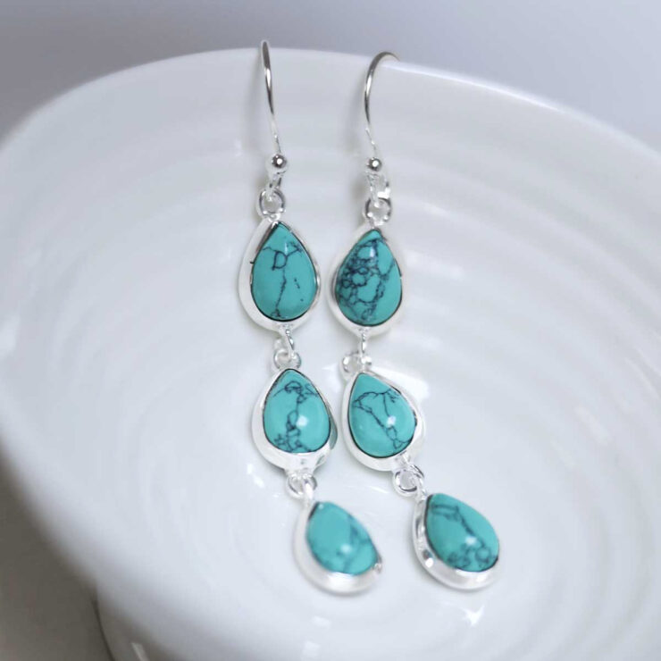 MJ753C_Sterling Silver Triple Turquoise Dangly Teardrops_1-2 Sterling Silver Triple Turquoise Dangly Teardrops on white dish