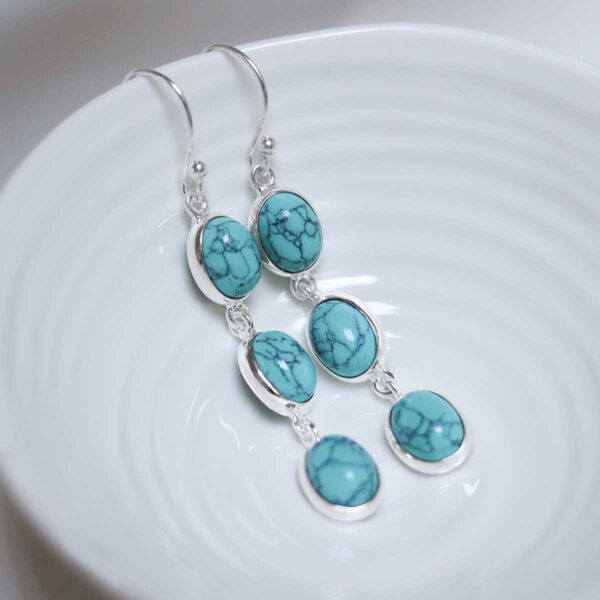 Sterling Silver Triple Turquiose Dangly Oval Earrings on white dish