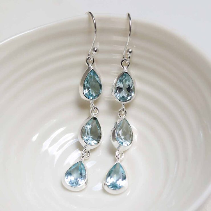 MJ754C_Sterling Silver Triple Blue Topaz Dangly Teardrops_2 Sterling Silver Triple Blue Topaz Dangly Teardrops on white dish