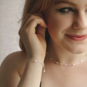 pearl bracelet and matching pearl necklace on model with red hair