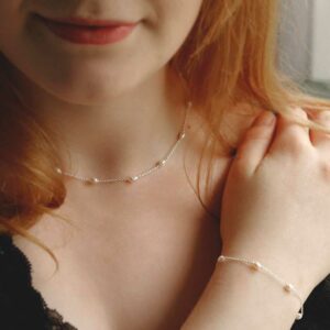 pearl bracelet and matching pearl necklace on model with red hair