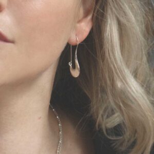 Liquid Curl Earrings worn by a model with blonde hair