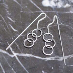 Sterling Silver Delicate Rings And Bar Threader Earrings on table