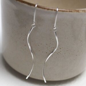 Sterling Silver Falling Threader Earrings hanging on cup