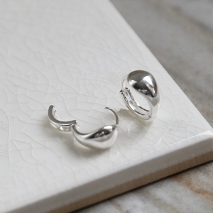 Sterling Silver Chunky Huggies on a white background. One earring open and one closed,