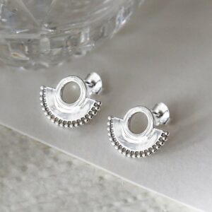 Sterling silver art deco sunburst stud earrings close up on great background