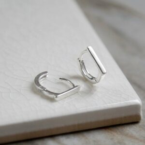 Sterling Silver Straight Edge Huggies on white background. One open and one closed.