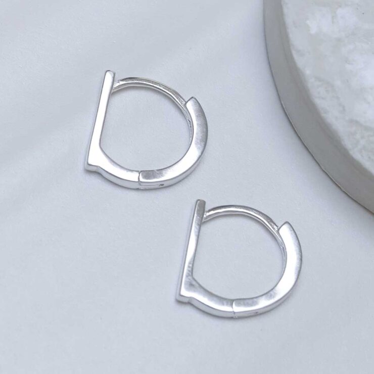 Sterling Silver Straight Edge Huggies on ceramic